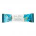The photograph shows a stack of 12 Jade & Joy Vegan Collagen Cookie Crumb protein bars in glossy wrappers. Each wrapper displays a pale green logo, brown cookie crumb imagery and a beige bar illustration. One bar is partially unwrapped, revealing a crumbly, speckled interior Under soft studio light