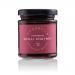 Six small clear glass jars sit in neat rows on a plain surface. Each jar shows glossy, ruby-red strawberry chutney with visible fruit pieces and fine red chilli flecks. White rectangular labels in elegant script and silver screw lids read Annabel’s Deliciously British Strawberry Chilli Chutney. Shot