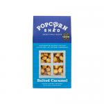 A photo shows ten sealed 80g bags of Popcorn Shed Salted Caramel popcorn arranged in a neat grid. Each bag displays warm amber caramel-coated popcorn with a slight glossy sheen, light salt crystals and the Popcorn Shed logo on crisp, modern packaging. Soft studio light and a neutral background. Soft