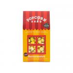 A glossy yellow-and-brown bag labeled Popcorn Shed and Butterscotch sits upright, revealing golden corn kernels glazed in amber through a clear window. Whimsical typography and scattered popcorn illustrations frame the brand name on the vibrant front panel. Soft highlights accentuate the sugar glaze