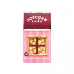 A group of ten compact bags sits in a neat grid, each packet showing golden popcorn flecked with toasted-marshmallow bits. Soft cream and caramel tones dominate the packaging, with playful lettering and an illustrated toasted marshmallow, suggesting warm, sticky sweetness. Shiny kernels glint anew.
