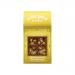A clear bag of golden popcorn studded with crumbly shortbread pieces and glossy caramel and chocolate drizzle sits spilling onto a wooden surface. Bright branded packaging rests nearby with scattered crumbs and a paper scoop; warm light highlights texture and sheen. Soft reflections kiss the popcorn