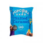 A neat display shows sixteen Popcorn Shed Salted Caramel snack packs arranged in a grid. Each 24g pouch features warm caramel tones, glossy highlights and a salted caramel label. Popcorn kernels peek through a clear window, evoking crunchy, glazed texture. Soft shadows accent kernels and glossy seals.