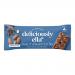 A neatly arranged box of 16 individual 50g cacao and almond oat bars sits against a pale background. Each wrapper shows warm brown and cream tones, cacao and almond imagery, clear branded logo and product name. A few bars are unwrapped, revealing textured oats and chocolate pieces. Soft light, rich.