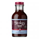 Six identical 320g bottles of Stokes Real Brown Sauce sit in a neat pack. Clear glass reveals dark brown sauce; each bottle displays the Stokes label and product name. Bottles stand upright with screw caps and uniform branding against a plain background.