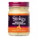 A pack of six Stokes Mustard & Honey Mayonnaise jars sits in a neat row, each clear glass jar topped with a silver lid and a cream-and-yellow label. Smooth pale golden spread with tiny mustard specks shows through the glass, label text and logo centered on each jar. Back label shows ingredient list.
