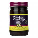 Six clear glass jars of Stokes Sticky Pickle are arranged in two rows; each 430g jar reveals amber-brown chutney studded with mustard seeds and fruit pieces. Cream labels show the Stokes logo with red and gold accents, topped by metal screw lids catching soft studio light. Slight condensation forms.