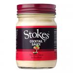 A photo shows six 210g glass jars of Stokes Cocktail Sauce, each filled with glossy deep-red sauce. The jars have black screw lids and white labels carrying the Stokes logo and product name. They stand clustered on a neutral surface with soft light reflecting off the glass.