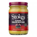 A cluster of glass jars labeled Stokes Classic English Mustard sits against a neutral background. Bright yellow mustard shows through clear glass; cream labels with a red Stokes logo and black text wrap each jar. Metal lids reflect soft studio lighting. They form two rows, labels slightly askew.