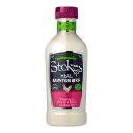 A squeezable white plastic bottle of Stokes Real Mayonnaise sits upright, its curved shape and flip-top cap visible. A cream-colored label shows the Stokes logo, product name and simple graphic elements. Multiple bottles appear together in a tidy row. Soft light shows glossy plastic and clear nozzle.