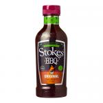 A group of ten squeezy bottles sits in neat rows, each translucent bottle revealing glossy, dark reddish-brown sauce. White flip caps and consistent labels show the Stokes Original BBQ Sauce name with bold typography and simple graphics, forming a tidy, uniform, colorful display. Light glints on top