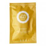 Honey-hued candy floss fills clear 12g pouches stamped SweetDoughThings. Ten neat pouches nestle in a branded box showing Honey Flavour and Sugar-Free labels, with playful swirls and warm yellow-orange graphics against a white background. Soft, fibrous strands catch light, giving a glossy, airy look.