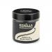 A glass jar of Bonilla Madagascan vanilla bean paste sits open, dark glossy paste streaked with tiny black seeds. A wooden spoon rests beside it, while whole vanilla pods and a few dried grains scatter on a pale surface, the label showing simple branding.
