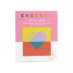 Neatly stacked milk chocolate bars display soft pink wrappers embossed with a heart and the phrase With Love beside the Chococo logo. Artwork indicates 47% cocoa and 75g; one bar is partly unwrapped, revealing smooth, glossy brown squares and fine sheen. Metallic foil accents glint over each wrapper