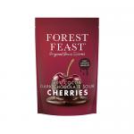 Photo shows six Forest Feast bars in artful arrangement with deep brown and maroon wrappers. One bar is unwrapped, revealing glossy Belgian dark chocolate squares studded with tangy red sour cherries and a scatter of seeds and chopped nuts. Soft shadows fall across a pale surface. A few crumbs scatter.