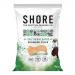 Twelve 80g Shore Seaweed Chips packets are arranged in a neat grid, each packet displaying deep blue and sea-green artwork, with dark green seaweed chips visible through a small clear window, a prominent 'Salt & Balsamic' label and simple Shore branding. Soft natural light highlights textures. Close