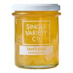 Six clear glass jars of Single Variety Co Tahiti Lime Marmalade sit in a neat row, each 225g jar revealing pale green-yellow preserves studded with fine citrus peel. Simple white labels and silver lids catch soft light, while glossy marmalade texture and tiny bubbles show through. On a wooden board.