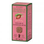 The image shows a rectangular brown box of Artisan Biscuits B&B Belgian Double Chocolate with rich chocolate graphics and bakery logo. Six dark, round biscuits are visible through a clear window; one is broken to reveal a dense, chocolate-speckled interior and melting chocolate chips.