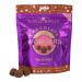 The photo shows a compact box of Booja-Booja Hazelnut Chocolate Wonders with deep brown and cream packaging. The Booja-Booja logo appears prominently beside glossy images of hazelnut-studded chocolate pieces and whole hazelnuts, with small product text.