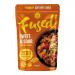 A glossy pouch displays a vibrant sweet-and-sour stir fry: glossy red-orange sauce coats bite-sized vegetables and protein; crisp bell peppers, pineapple chunks, sliced onions and scallions contrast with sesame seeds and a cilantro sprig. The label shows bold brand lettering and simple graphics HDR