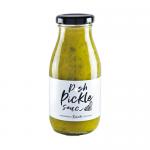 A clear glass jar with a metal screw lid holds golden-brown pickle sauce flecked with spices. A cream label wraps the jar with hand-drawn illustrations, bold dark lettering of the brand and product name, and decorative borders. Six jars stand in a neat row. Soft studio lighting casts warm highlight.