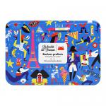 A colorful rectangular box of Le Chocolat des Français sits centered, showing the brand logo and a small French tricolor. Opened chocolates display glossy dark and milk praline rochers in neat rows, their textured hazelnut-studded surfaces and creamy centers visible. Soft light accents glossy finish.