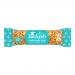 A dozen slim, brown-and-cream wrapped bars bearing the Joe & Seph’s logo sit in neat rows. One bar is unwrapped to reveal glossy salted caramel-coated popcorn studded with chopped nuts, with a few loose kernels and nut fragments scattered on a white background.