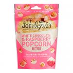 The image shows a branded packet of Joe & Seph’s White Chocolate & Raspberry Popcorn Bites. The pale-pink and cream packaging features the logo, stylized popcorn clusters coated in white chocolate, scattered freeze-dried raspberry pieces, and elegant typography with a glossy finish. Matte gold trim.