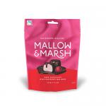A festive pouch displays six raspberry marshmallows, each enrobed in glossy 70% dark chocolate. Deep magenta centers peek where the coating cracks, contrasting with the rich brown sheen. Packaging shows winter motifs in red and green and a clear window revealing the confections. Light sugar dusting.