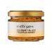 A set of six 90g glass jars of Truffle Guys Gourmet Truffle Honey sits arranged in a row inside a festive gift box. Warm amber honey shows dark truffle flecks. Each jar bears a minimalist black-and-white label with the Truffle Guys logo and gold lids reflecting light. Soft highlights on glass gleam.