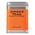 A boxed Jinger Drinks ginger and turmeric tea sits amid a festive Christmas scene. Bright red and gold packaging displays ginger root and turmeric slices. A steaming cup and loose tea bags rest nearby, surrounded by pine sprigs, cinnamon sticks and soft falling snowflakes. Warm glow accents details.