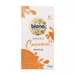 A rectangular pack shows a stack of golden-brown waffles glazed with glossy caramel syrup, set on a warm beige background. A green Biona logo appears prominently, with clean white lettering for the product name and organic badges.