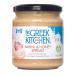A rectangular box of six 300g jars of The Greek Kitchen Tahini & Honey spread sits aligned in two rows. Labels show beige tahini swirls, golden honey drips and the brand logo with minimalist blue accents. Glass jars reveal creamy, pale beige spread inside. Light catches glossy lids and faint hues.