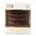 A rectangular bakery box uses deep brown and cream tones. The front displays stacked double chocolate chip biscuits with glossy chocolate chunks and crumb texture in close-up. A stylized logo occupies a corner while ingredient and recycling icons line the side panel. Background shows cocoa accents..