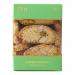 An elegant rectangular box shows a neat row of golden-brown biscottini through a clear window, each crisp slice speckled with toasted almonds and bright green pistachio pieces. Crumbly texture, light sugar dusting and simple label rest against a warm, neutral backdrop. soft shadows accent warm tones