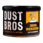 A bright photo showing a stack of Dust Bros Jerk Berzerk snack packs inside a grocery box. Bold tropical graphics and fiery red-orange accents wrap each 65g packet, featuring a stylized logo, peppers and island motifs. Twelve uniform packets align neatly, front labels facing forward. Subtle depth cues.