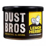 A bright yellow packet labeled 'Dust Bros' bears a bold black-and-white logo and stylized lemon and herb illustrations. Clean typography reads 'Lemon Herbet' and '65g'. Twelve identical packets sit neatly stacked inside a plain corrugated box.