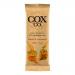 A small rectangular chocolate bar rests on a neutral surface in cream-and-caramel packaging bearing the Cox&Co. logo and bold type. One bar is unwrapped, revealing glossy dark chocolate squares topped with tiny caramelized flakes.