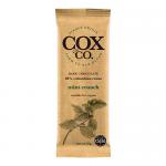 A neat row of 25g Cox&Co. chocolate bars shows sleek wrappers in deep brown and mint green, the label highlighting 60% Mint Crunch beside a stylized cocoa bean and mint leaf. One bar is partly unwrapped to reveal dark chocolate studded with mint crisps.