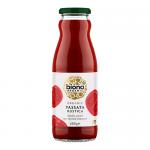 A clear glass jar filled with chunky deep-red tomato passata stands upright against a plain background. The green-and-white label reads Biona Organic Passata Rustica, showing rustic tomatoes and simple typography; a metal lid caps the jar, catching a soft highlight. Subtle glass reflections. Glint.