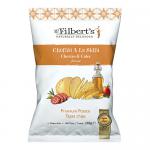 A vibrant red-orange crisps bag displays the Mr Filberts logo at top, a stylised chorizo and apple cider splash illustration, scattered golden potato tapas crisps across the front, weight and flavour text in bold type against a textured background.