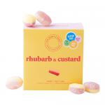 Photo shows a bright rectangular box of Ask Mummy & Daddy Rhubarb & Custard sweets. Retro pastel design displays playful typography, illustrated rhubarb and custard, striped accents and a clear window revealing individually wrapped pink and yellow chews.