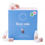 Photo shows an open Ask Mummy & Daddy Fizzy Cola Bottles box. Ten sugar-dusted, cola-shaped gummies sit in rows, brown and red translucent, emitting tiny sugar crystals. Box art displays playful logo, fizzy bubble motifs and a retro soda-bottle illustration. Bright gloss and shadow add depth. Soft-lit.
