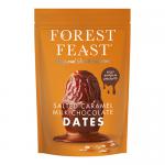 A glossy box of Forest Feast Salted Caramel Milk Chocolate Dates sits against a soft neutral background. The packaging shows the brand logo, an image of chocolate-coated dates with caramel drizzle, weight and '6' pack indication, plus leafy design accents. Soft lighting and a shallow depth of field.