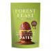Image shows six Forest Feast Pistachio Crisp Dates 120g packs laid in two rows on a white background. Each green pack bears pistachio and date illustrations, bold name text, a small nutrition panel and a clear window revealing glossy, dark brown dates inside.
