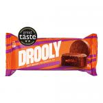 A Drooly Chocolate item from Drooly Bakery sits on a neutral background. The wrapper shows rich brown tones, a bold logo and glossy highlights. The image captures textured chocolate graphics, a folded seam on the packaging and soft studio lighting reflecting off the surface.