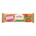 A rectangular retail box sits upright, its bright warm-brown packaging featuring the Boka logo and green accents. An individual wrapper mirrors the box design. An unwrapped chewy cereal bar rests in front, revealing golden cereal clusters bound by glossy caramel and a drizzled caramel ribbon. Close.
