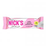A glossy rectangular wrapper displays the N!Cks logo in bold white letters on a dark band. Salty Peanut appears in contrasting text. A photograph of peanuts and coarse salt sits beside a partially unwrapped bar showing peanut pieces, caramel sheen, and textured nougat. Soft, neutral background hues.