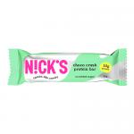 The image shows a single N!Cks Protein Bar Choco Crush in a bright matte wrapper. Rich brown and cream tones feature a bold logo, chocolate-drip graphics and scattered cocoa nibs. A partially unwrapped bar reveals dense chocolate, crunchy bits and a glossy chocolate coating. Subtle highlights on bar.