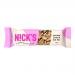An image shows a single N!Cks Vegan Nut Bar Peanut Crunch in a sealed 40g wrapper. The package features bold N!Cks branding, peanut imagery and a visible nut bar cross-section, using green and beige color blocks. The bar rests on a neutral background. Subtle texture and small ingredient icons appear